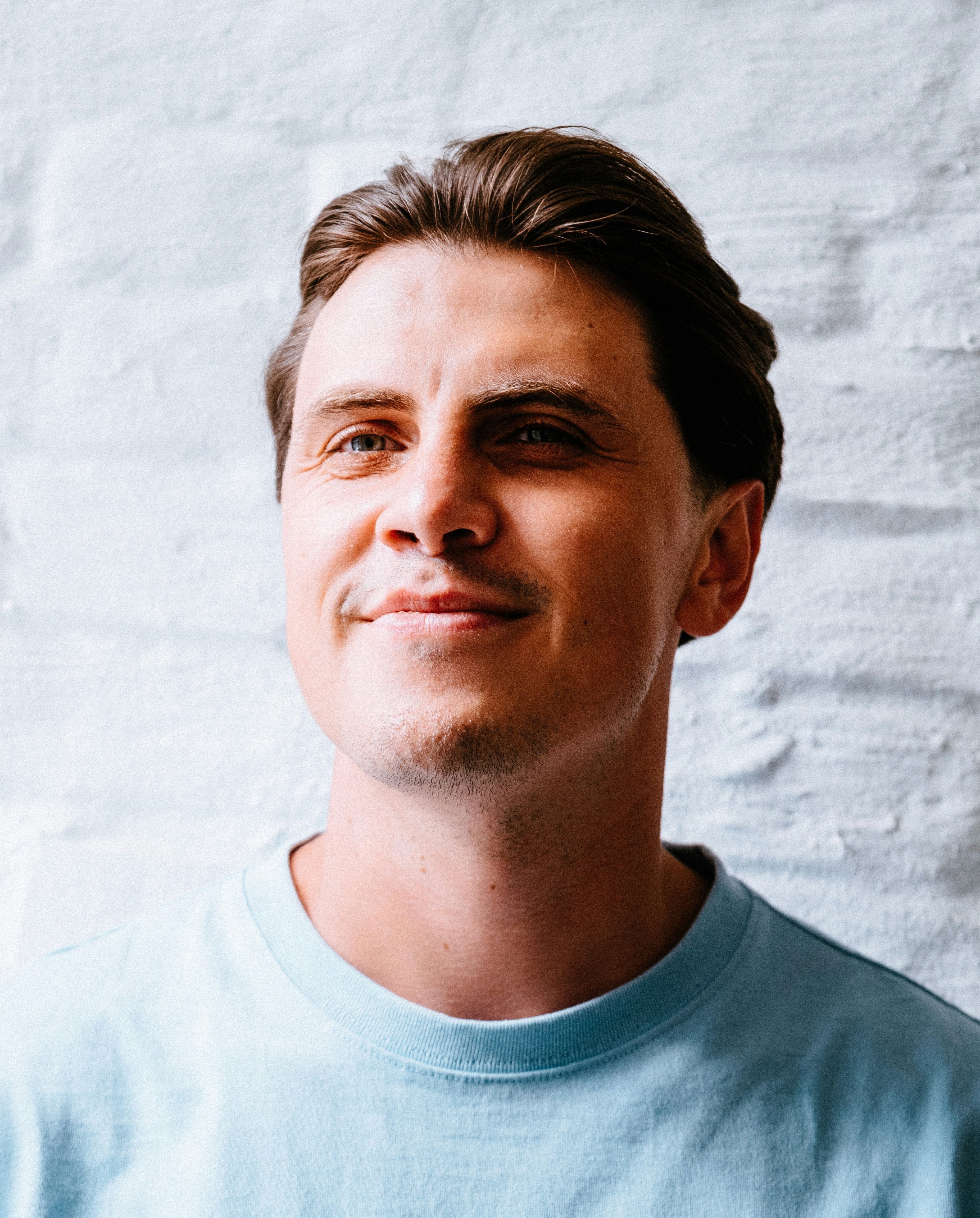 Pastor Pete Bend, a white man in his mid thirties, smiling wearing a blue sweater.